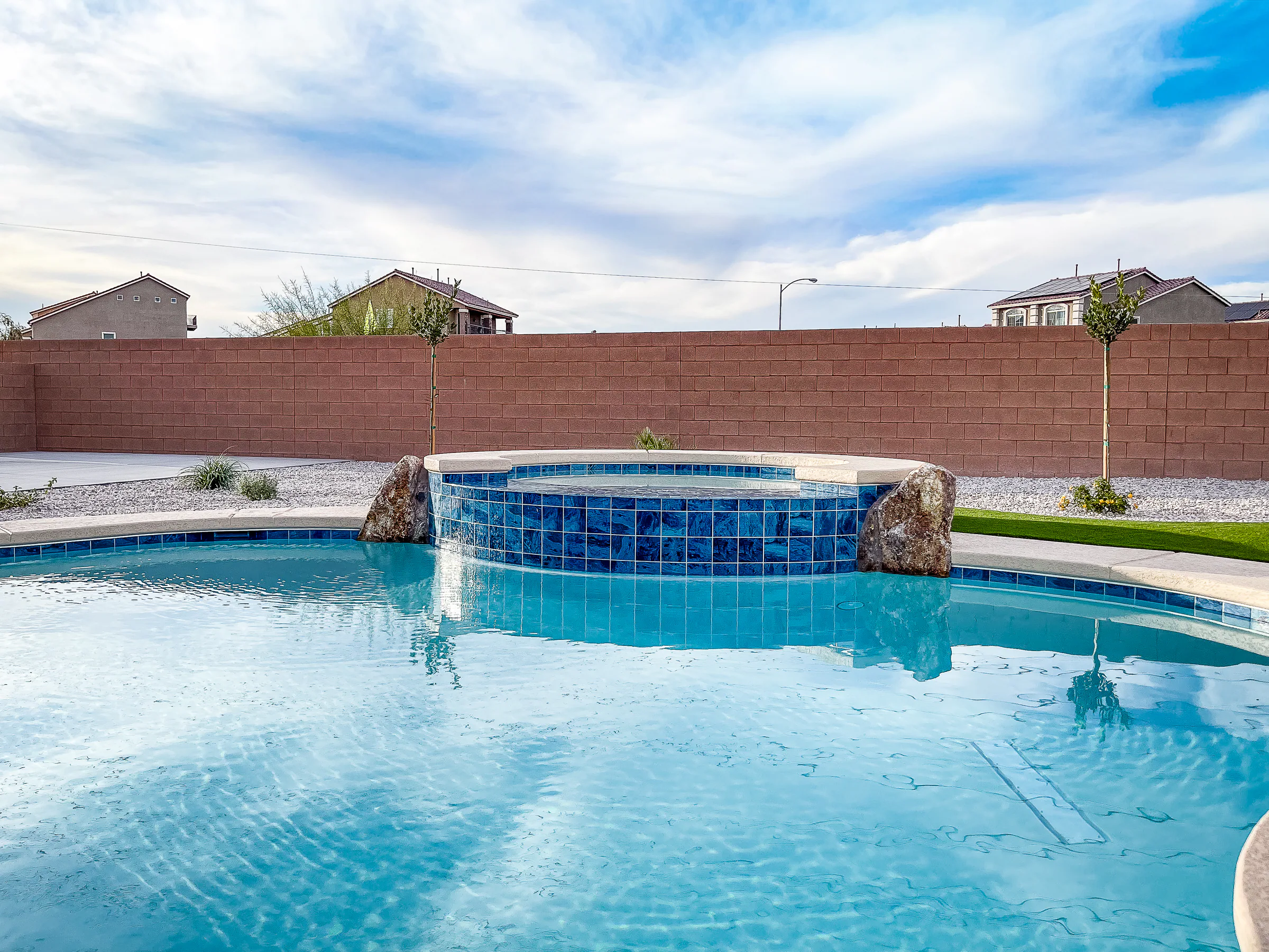 Garde project showing raised tile spa boulders calm water