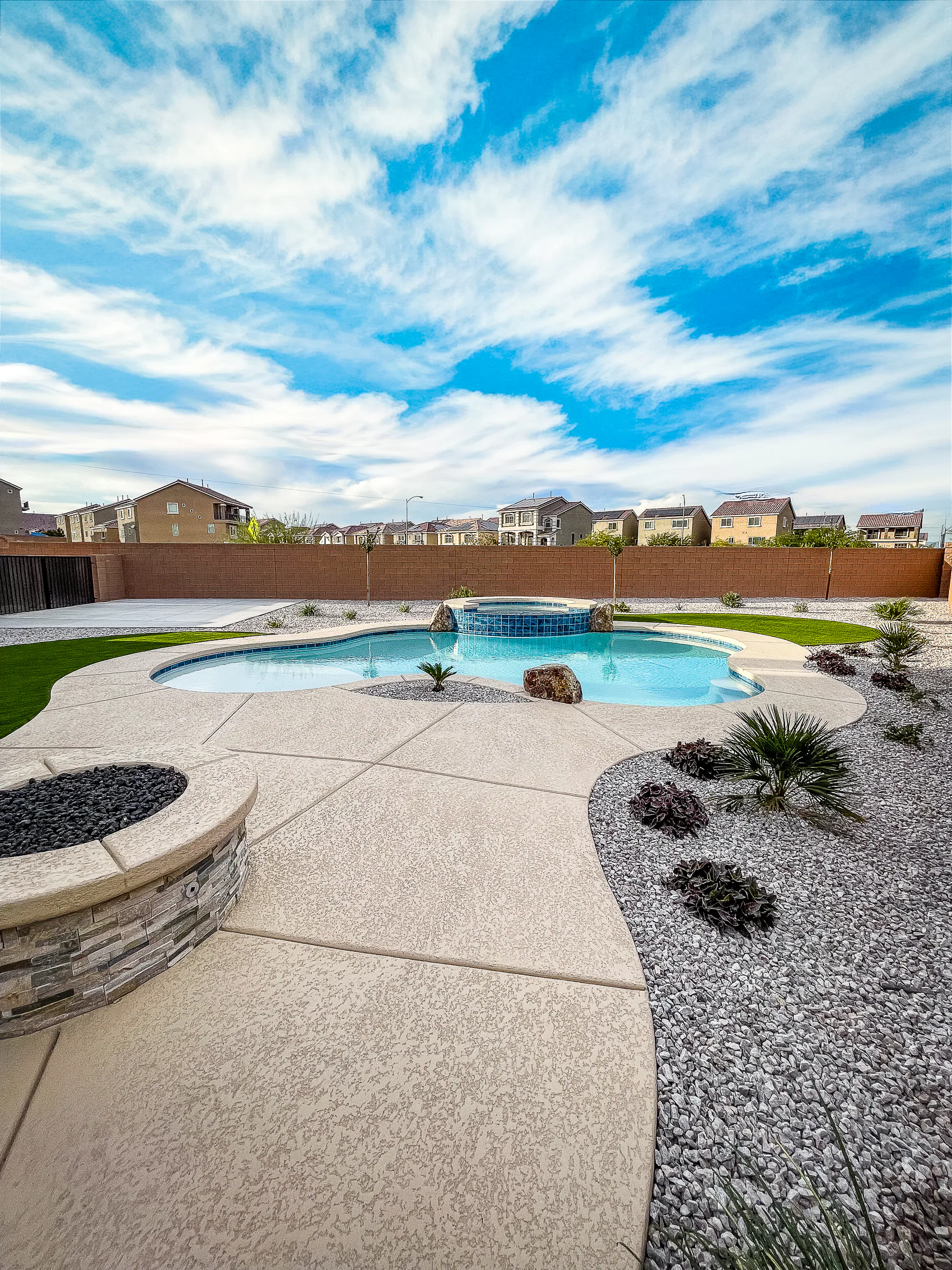 Garde project showing wide fire pit freeform pool turf curves