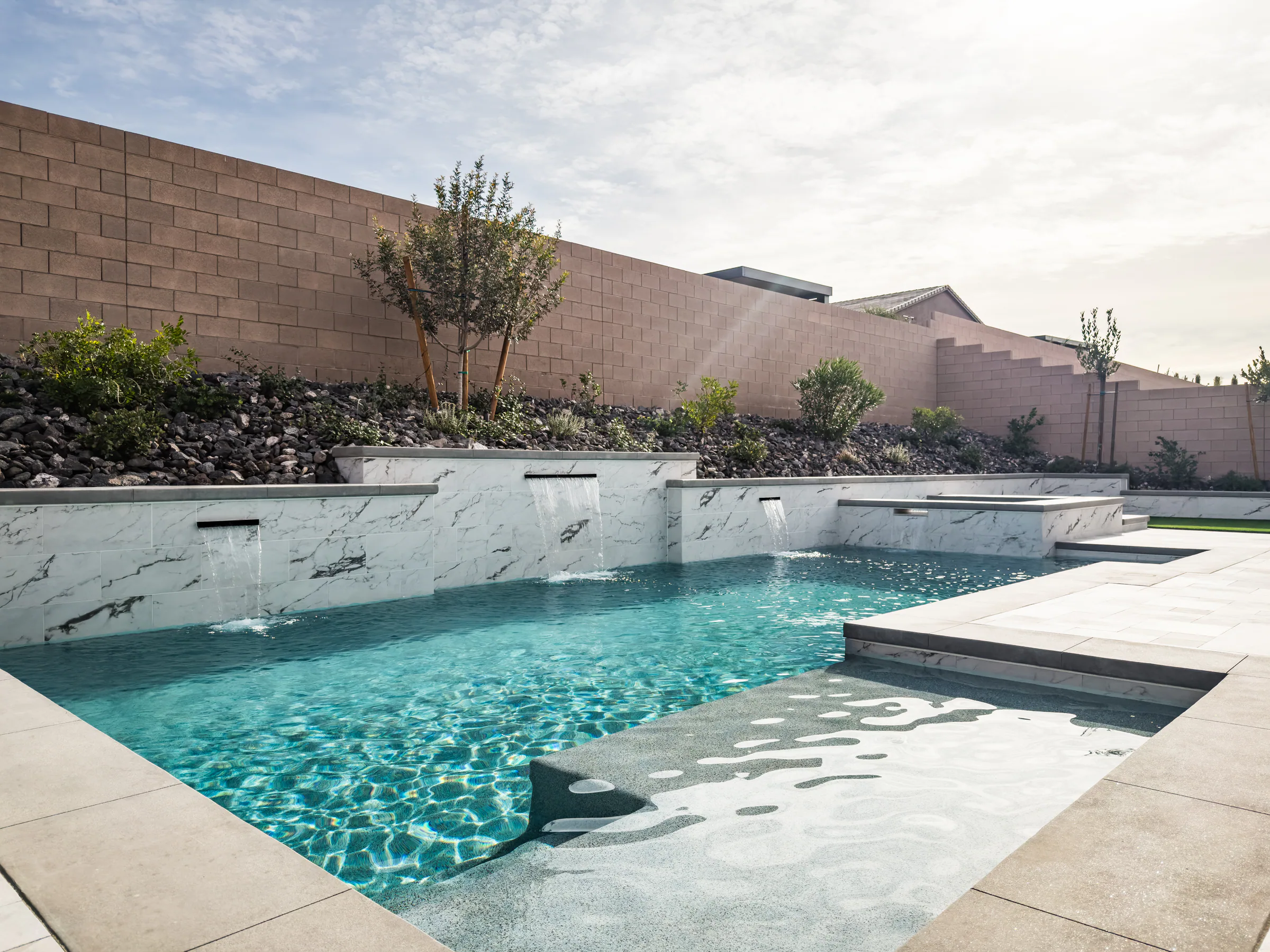 Guined project showing wide pool scuppers tanning ledge tan wall