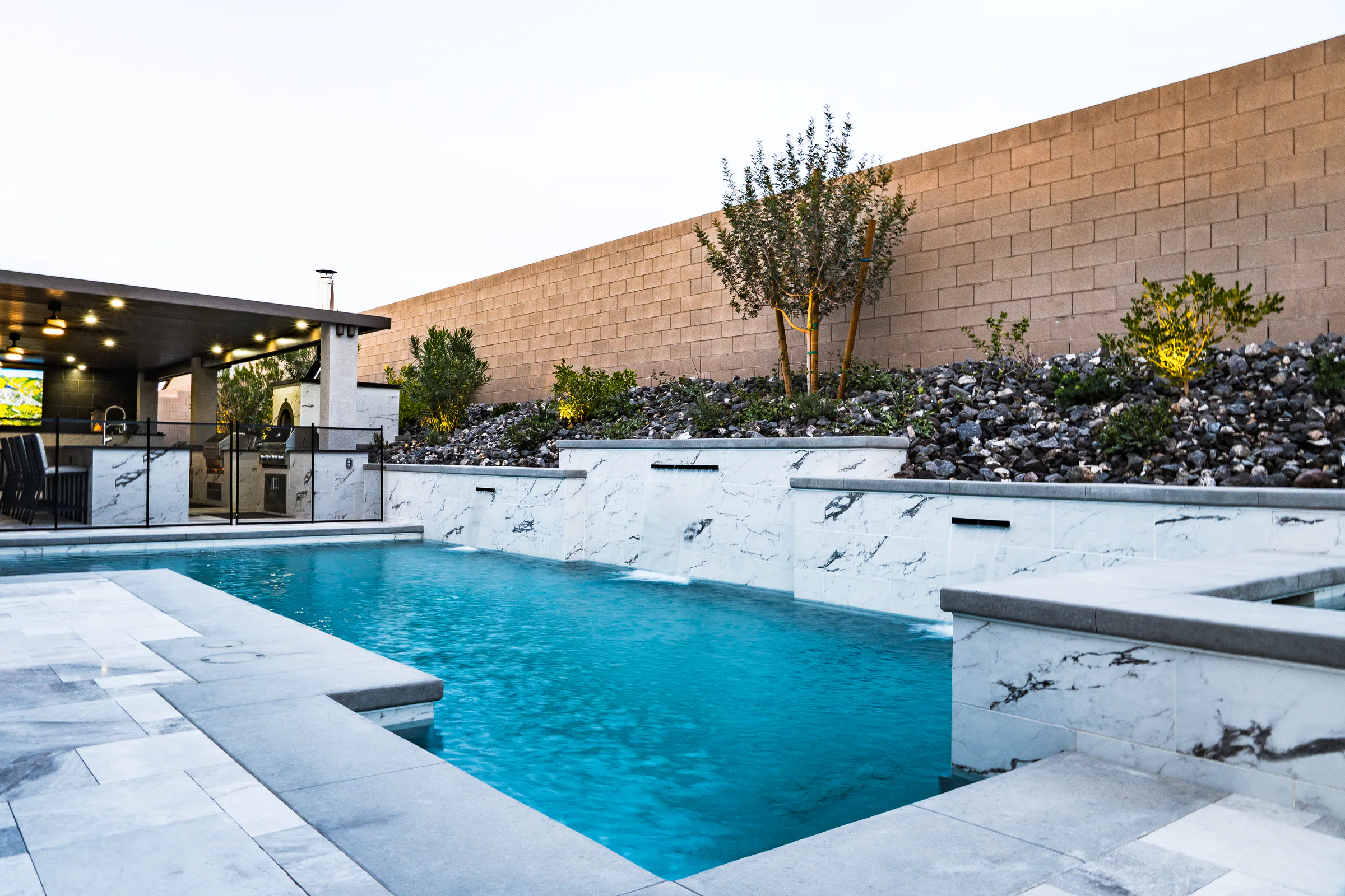 Guined project showing pool marble walls outdoor kitchen left
