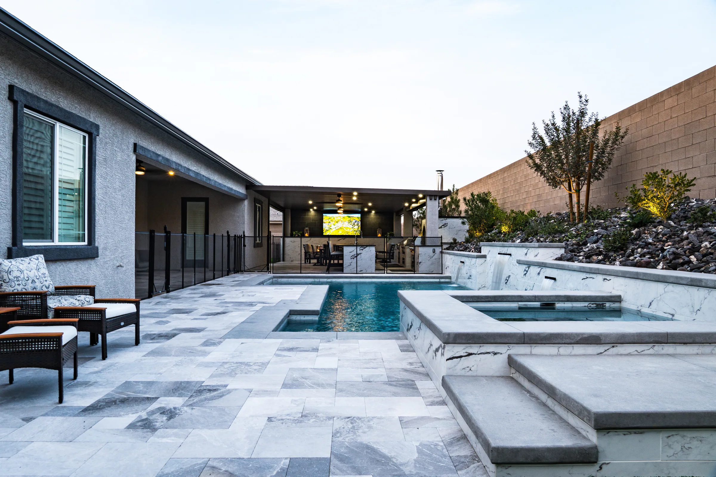Guined project showing wide pool spa house pavilion lounge chairs