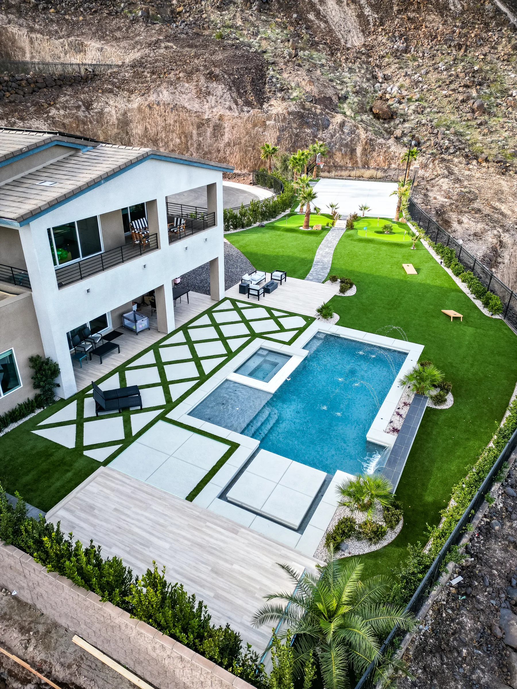 Aerial view of a home pool, spa, and landscaped backyard