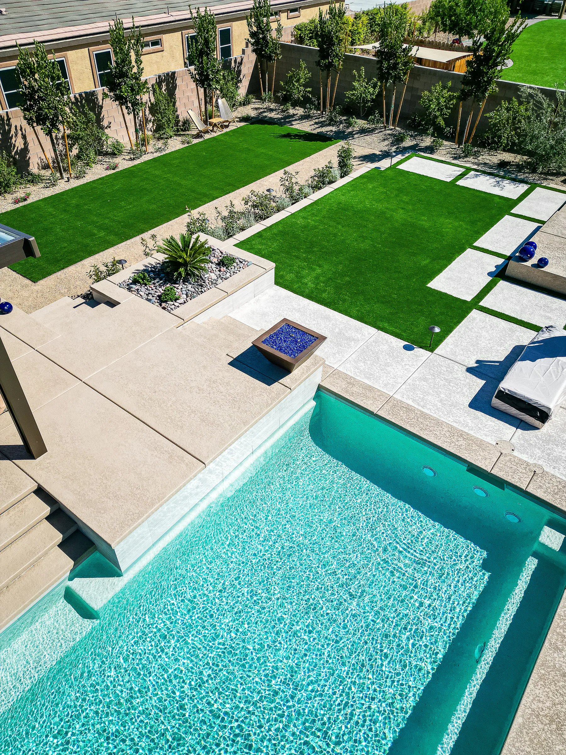 Hayes project showing aerial pool blue glass fire pit lawns
