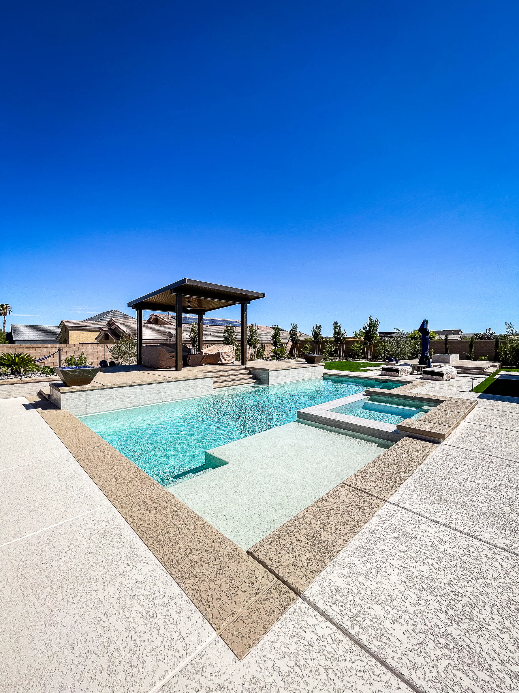 Hayes project showing wide pool baja shelf pergola tan coping