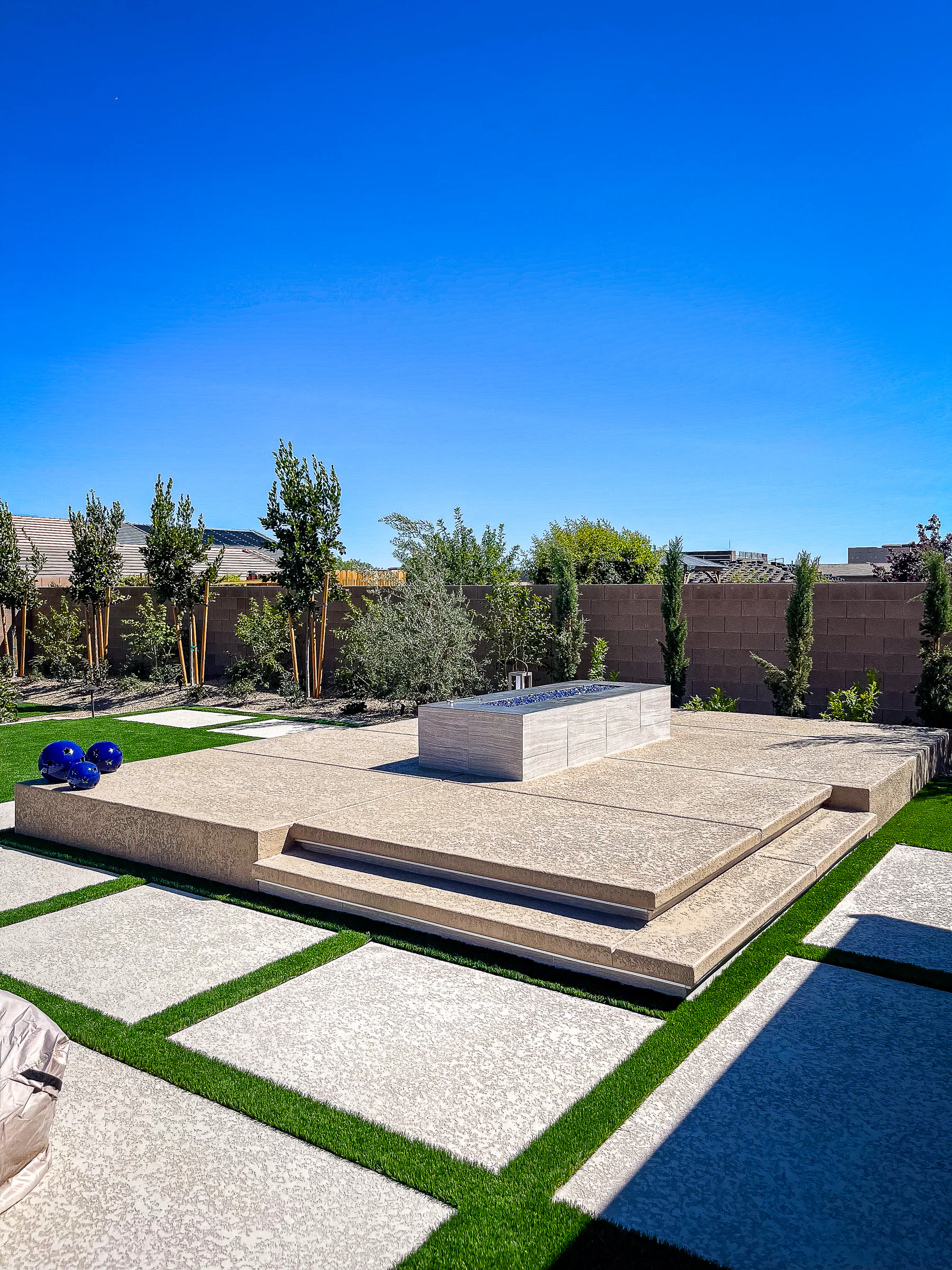 Hayes project showing wide turf paver patio fire pit platform