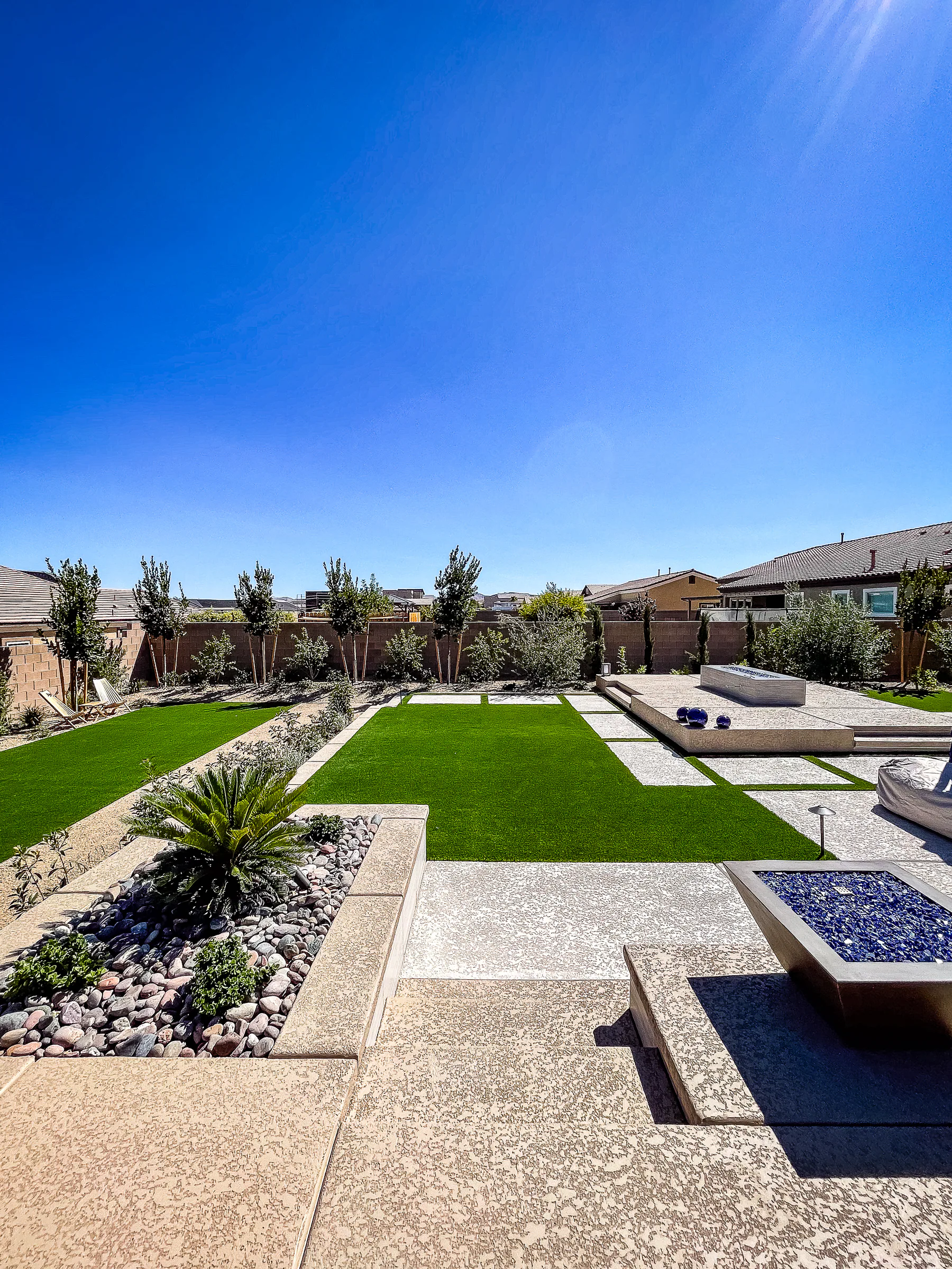 Hayes project showing wide turf yard fire pit foreground platform