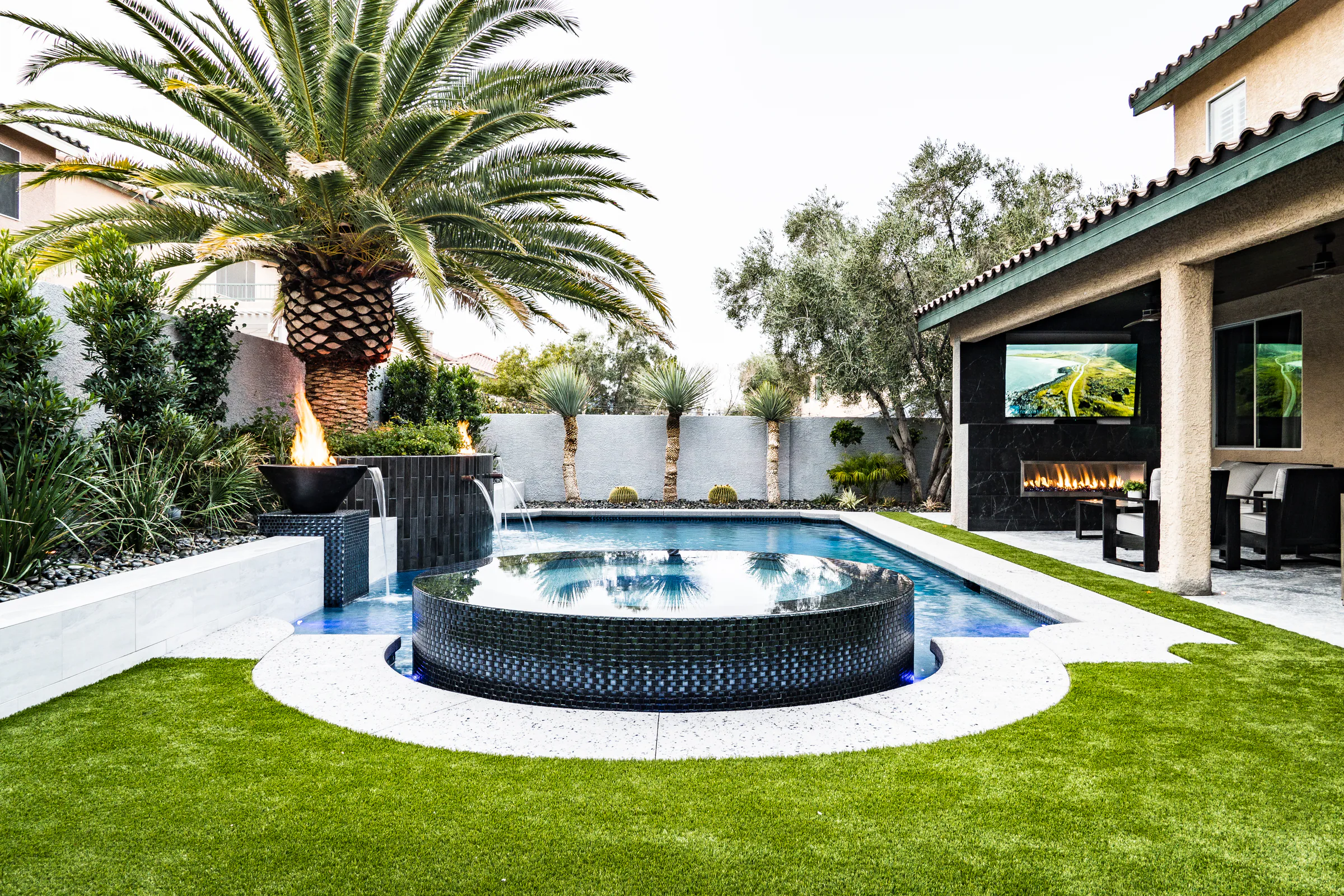 Medallion project showing wide backyard spa palm patio fireplace