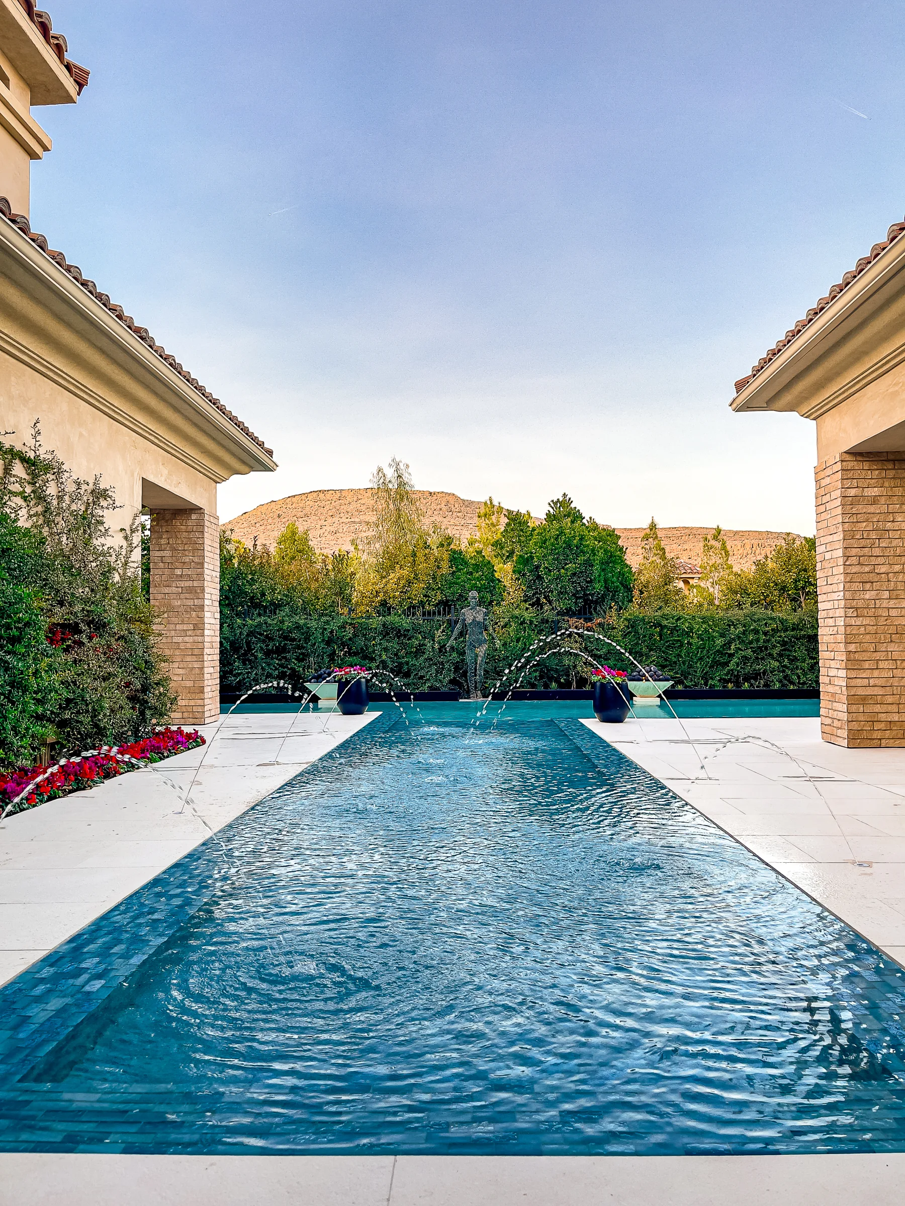 Symmetric lap pool with jets and mountain backdrop