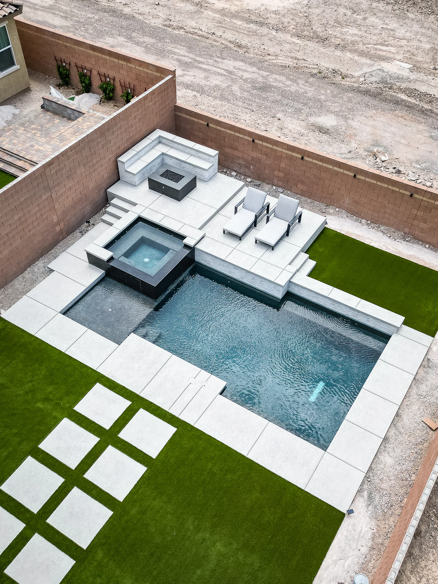 Palmer project showing drone aerial angled pool spa firepit loungers