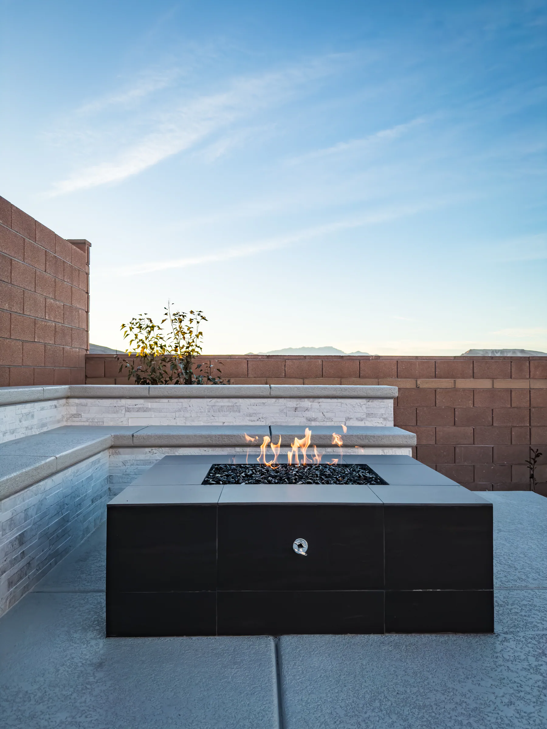 Palmer project showing closeup firepit flames bench mountains