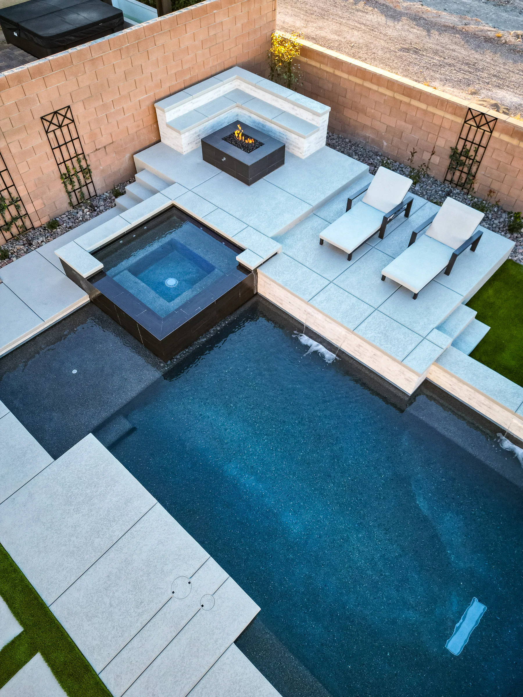 Palmer project showing drone aerial spa firepit lit loungers