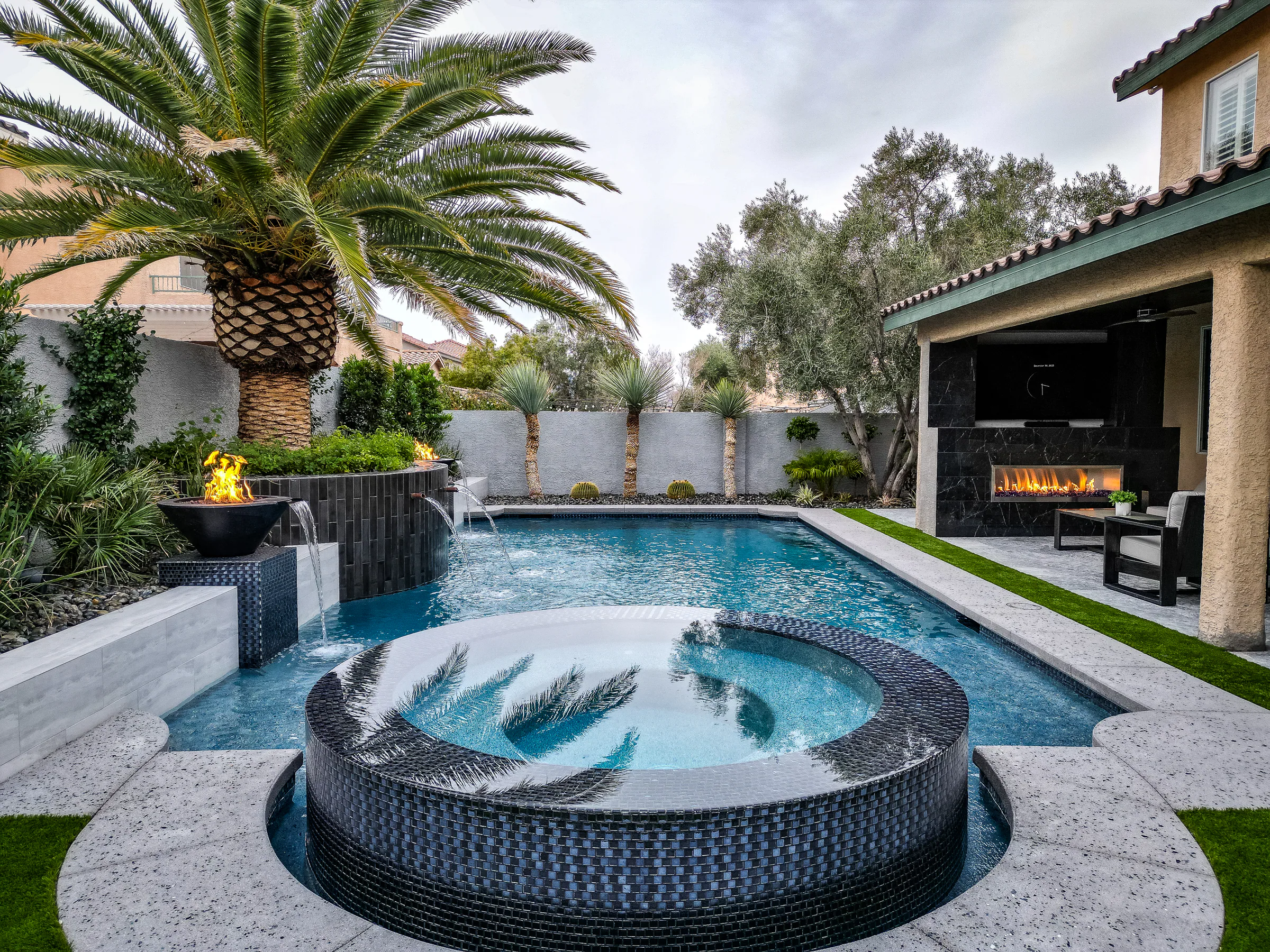 Medallion project showing rob desjardins drone elevated backyard spa cabana fireplace