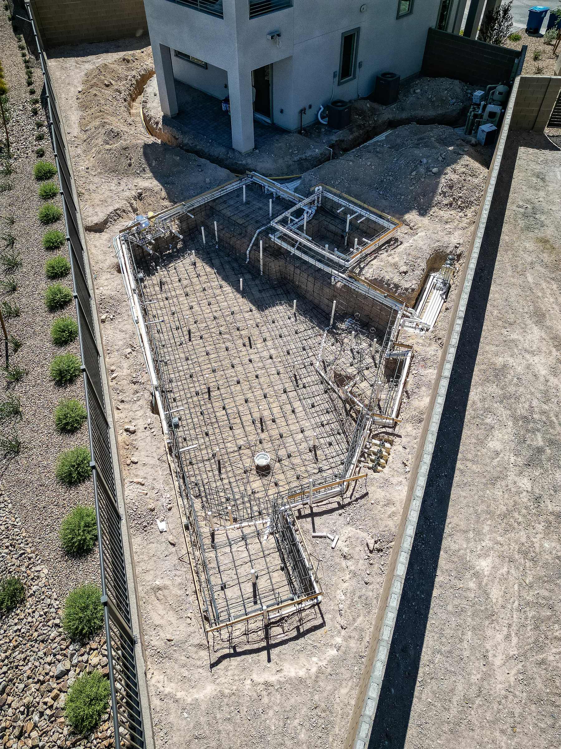 Plumbing lines and steel framing in place for the pool and raised spa