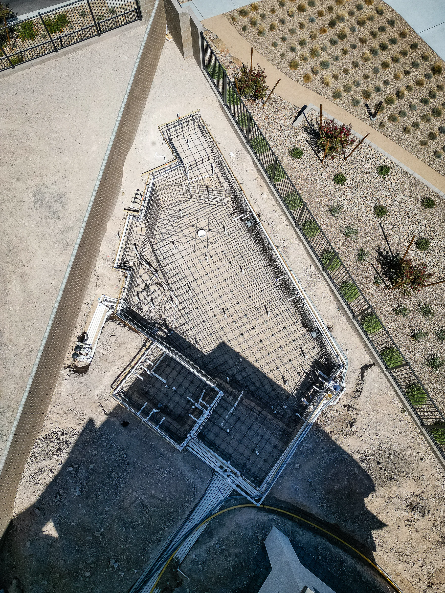 Steel rebar grid outlining the angled pool and spa before shotcrete