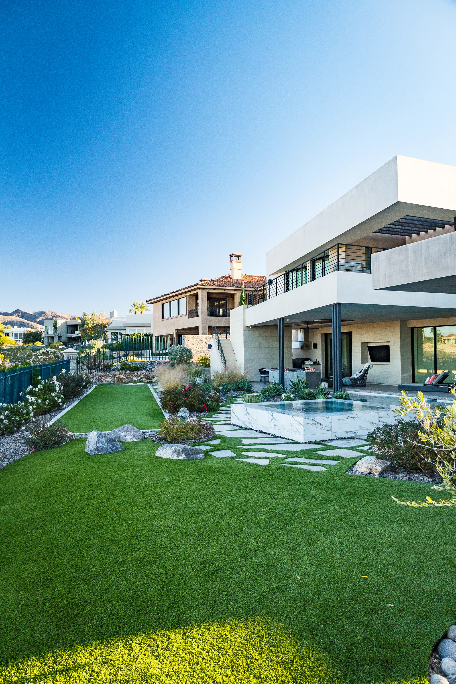 Strangis project showing wide turf lawn marble spa modern home