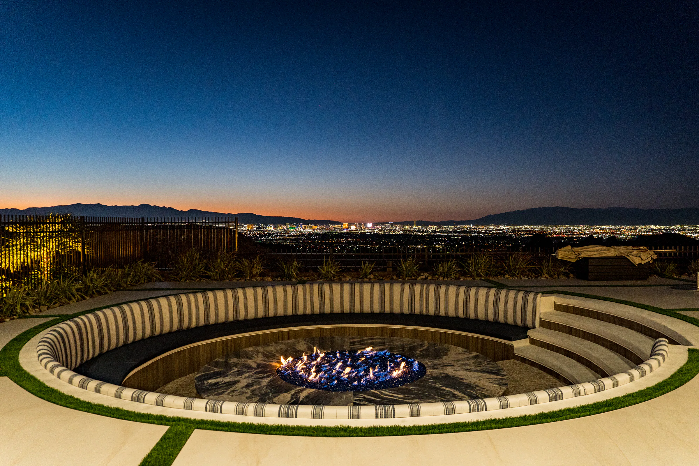 Sunken circular fire pit with built-in striped seating overlooking the Las Vegas valley