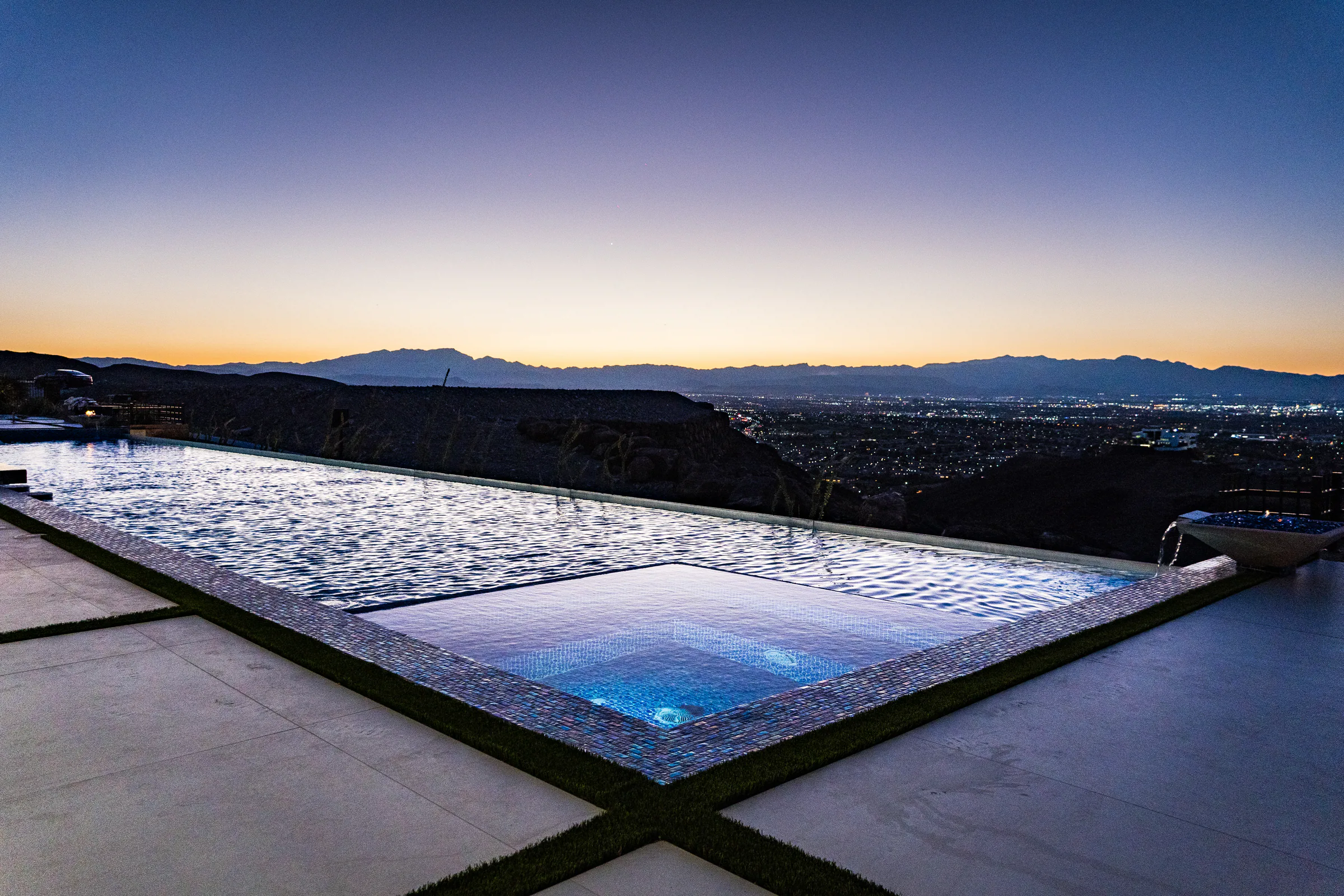 Glass-tile spa set into the infinity pool above the Las Vegas valley at sunset