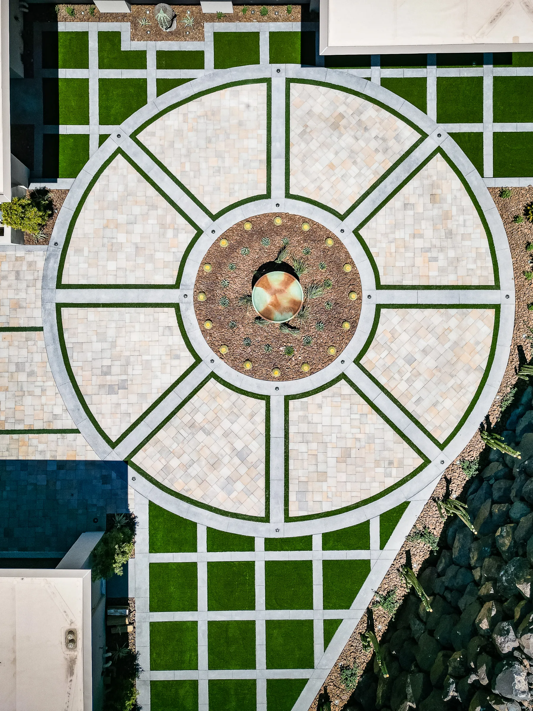 Top-down view of a circular landscaped courtyard with a turf grid